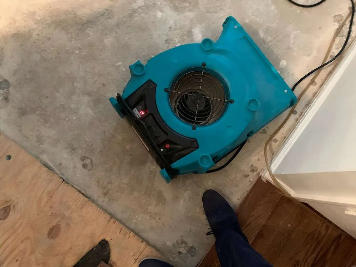 Air mover drying subfloor during Commercial Water Damage Restoration in Butner